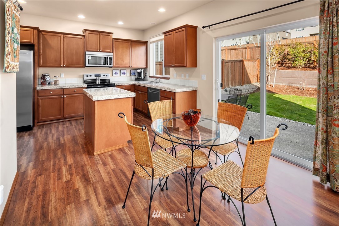 23019 42nd Drive Southeast Bothell, WA 98021 - Photo 4 of 19 a kitchen with stainless steel appliances a table and chairs in it