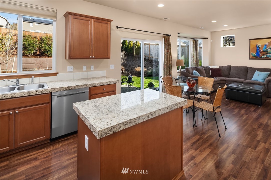 23019 42nd Drive Southeast Bothell, WA 98021 - Photo 6 of 19 a kitchen with a stove a sink a microwave a dining table and chairs