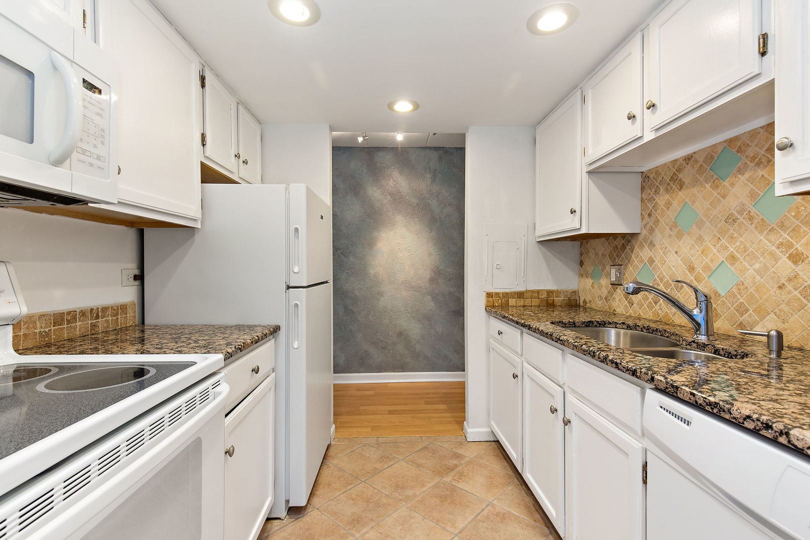 1 Renaissance Place, Unit 702 Palatine, IL 60067 - Photo 3 of 10 a kitchen with granite countertop a sink stove and refrigerator