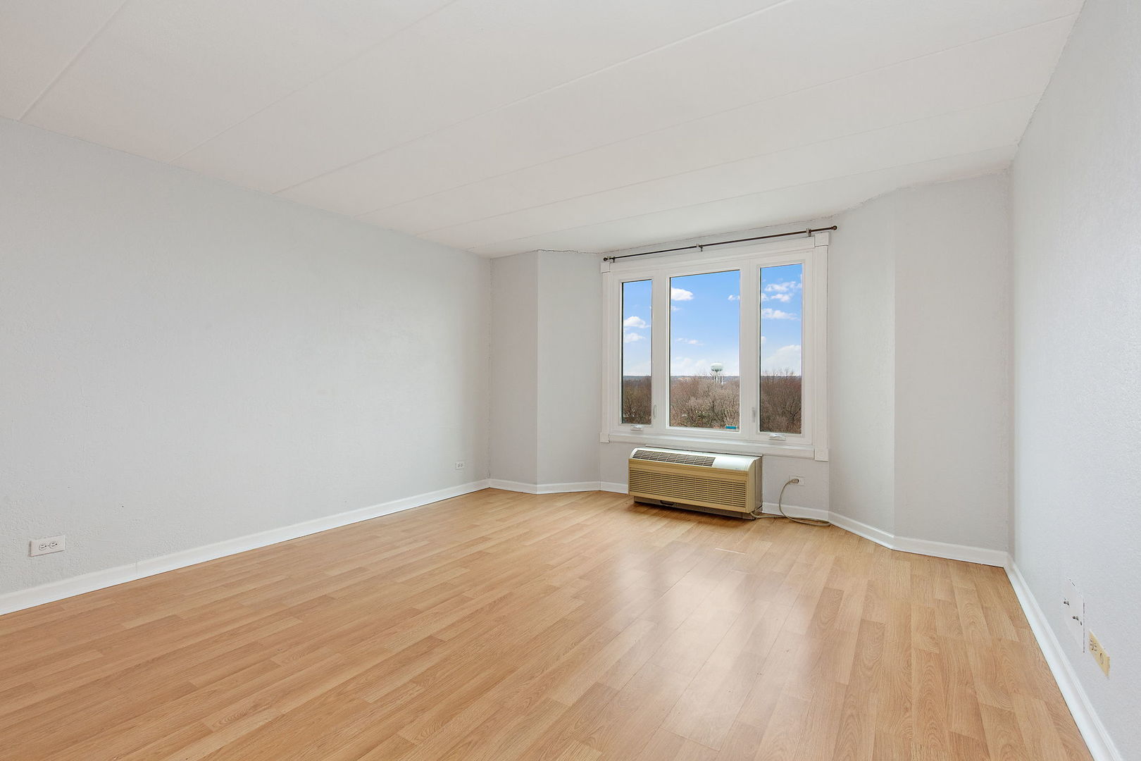 1 Renaissance Place, Unit 702 Palatine, IL 60067 - Photo 6 of 10 a view of an empty room with wooden floor and a window