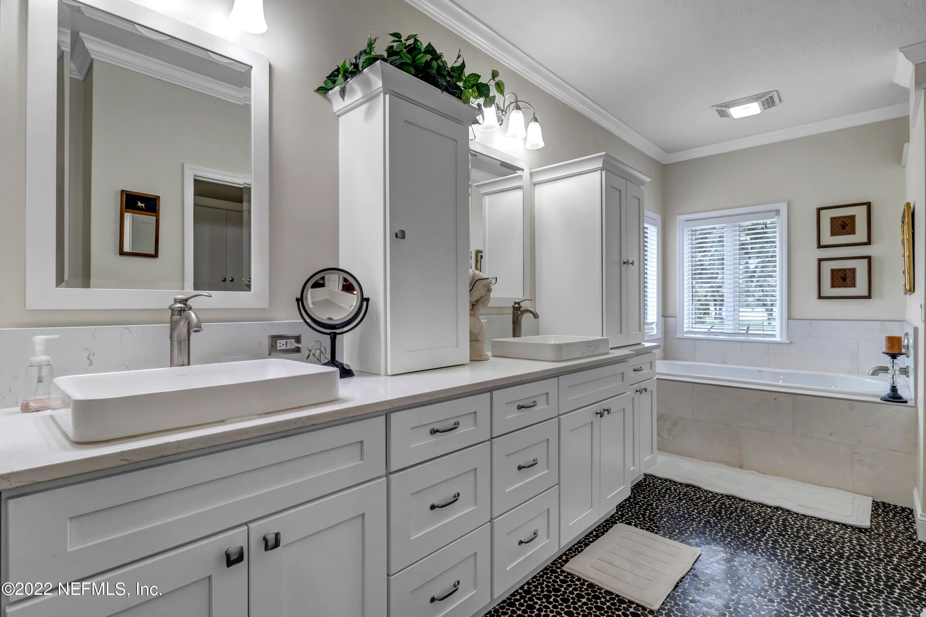 152 Marvin Jones Road Crescent City, FL 32112 - Photo 25 of 83 a bathroom with double vanity sinks double vanity tub shower and a mirror