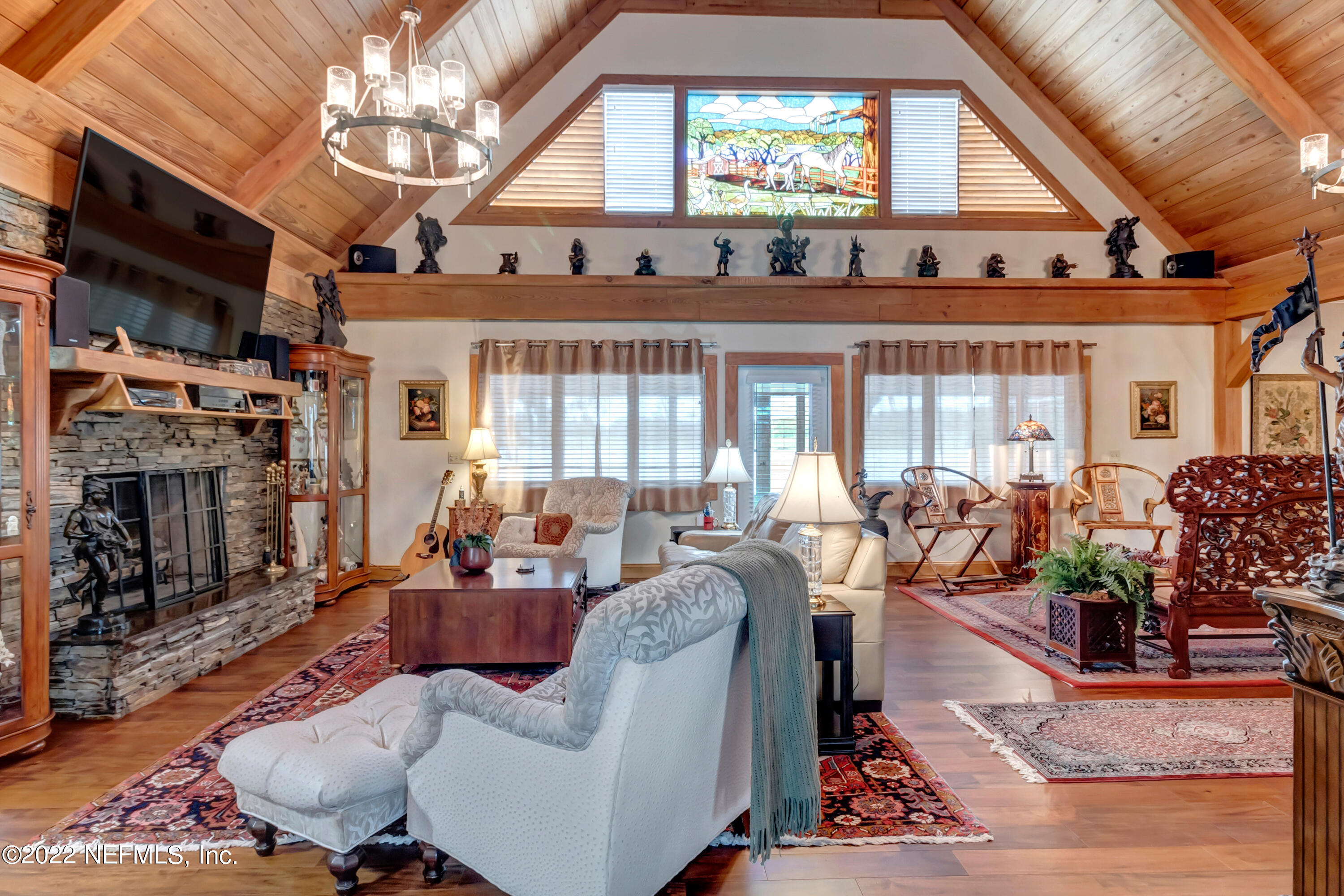 152 Marvin Jones Road Crescent City, FL 32112 - Photo 31 of 83 a living room with furniture a chandelier and a fireplace