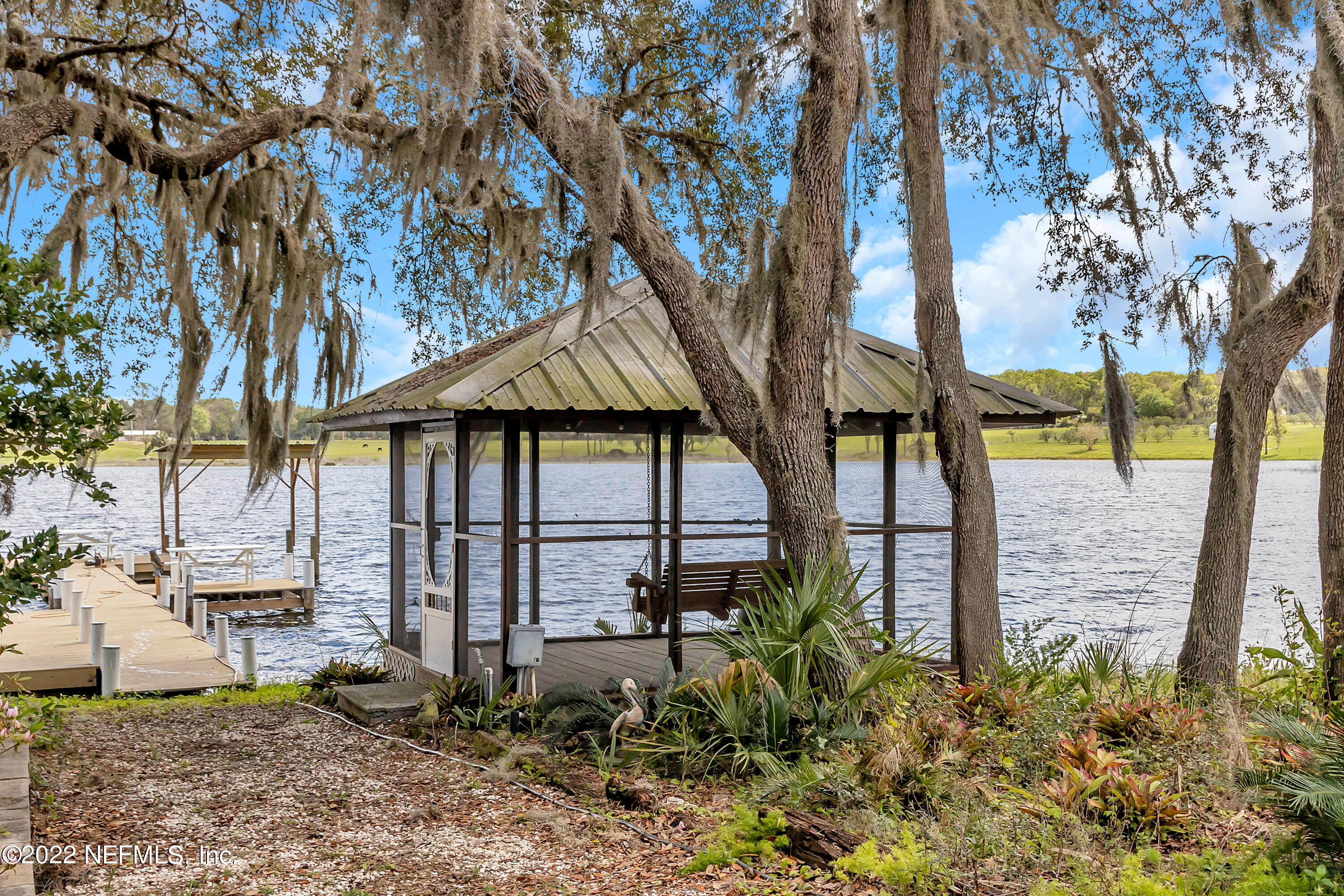 152 Marvin Jones Road Crescent City, FL 32112 - Photo 41 of 83 a view of a house with large trees and sitting area