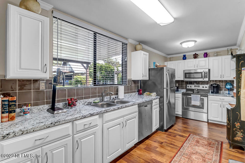 152 Marvin Jones Road Crescent City, FL 32112 - Photo 47 of 83 a kitchen with refrigerator and cabinets