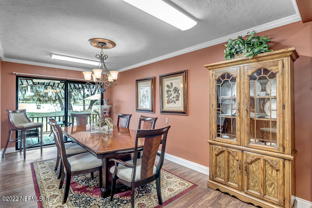 152 Marvin Jones Road Crescent City, FL 32112 - Photo 48 of 83 a dining room with furniture a chandelier and wooden floor