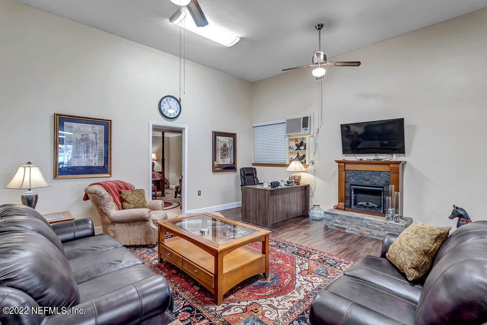 152 Marvin Jones Road Crescent City, FL 32112 - Photo 49 of 83 a living room with furniture a fireplace and a flat screen tv