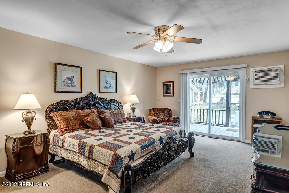 152 Marvin Jones Road Crescent City, FL 32112 - Photo 51 of 83 a bedroom with a large bed and a chandelier