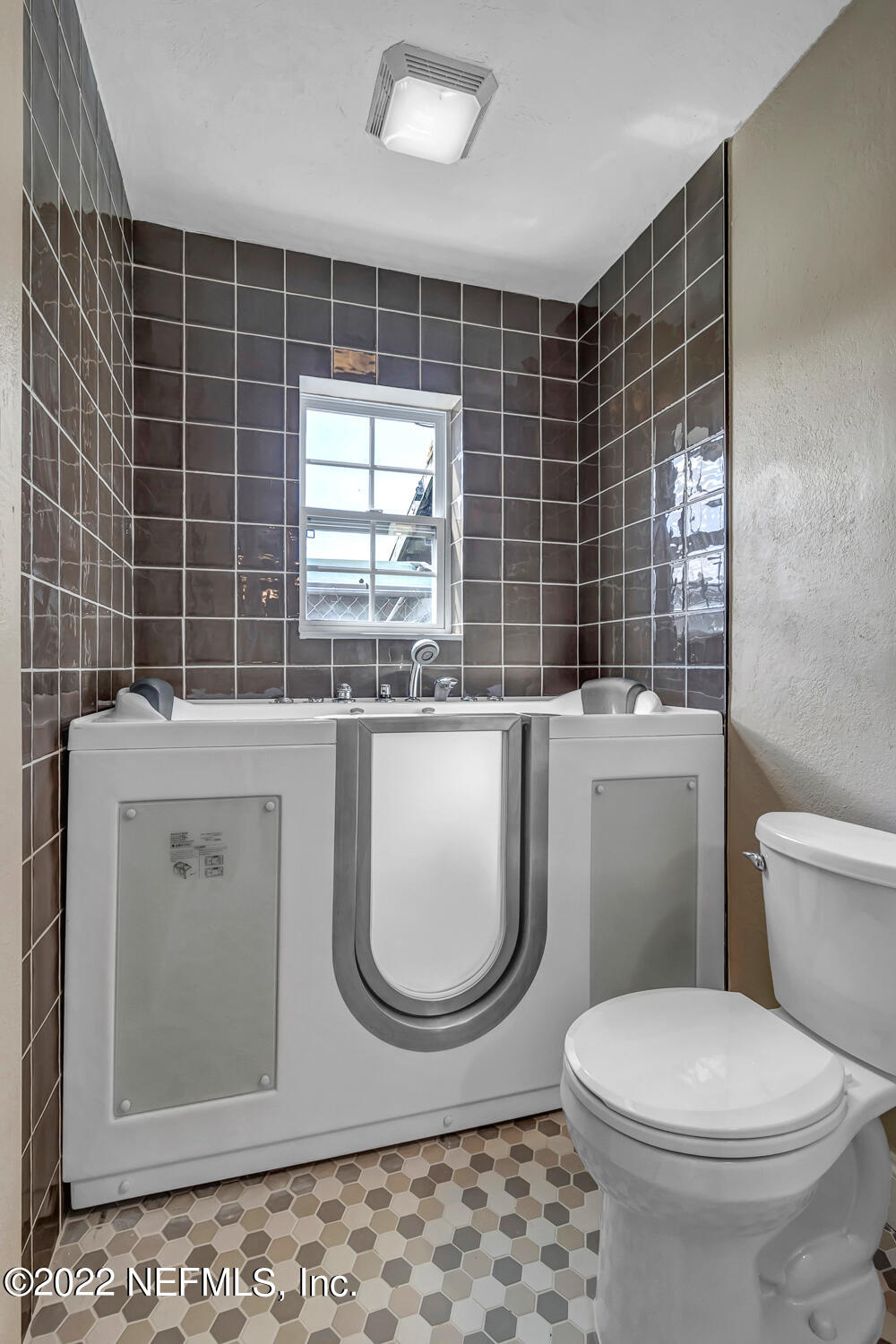 152 Marvin Jones Road Crescent City, FL 32112 - Photo 54 of 83 a bathroom with a granite countertop toilet a sink a mirror and a shower