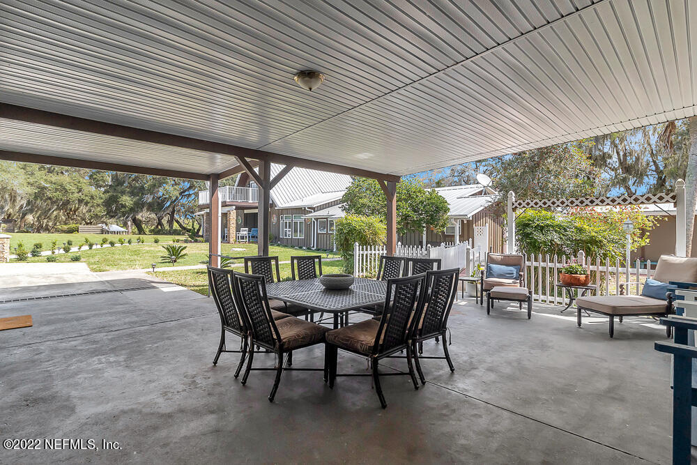 152 Marvin Jones Road Crescent City, FL 32112 - Photo 61 of 83 a view of a patio with a table chairs and a backyard