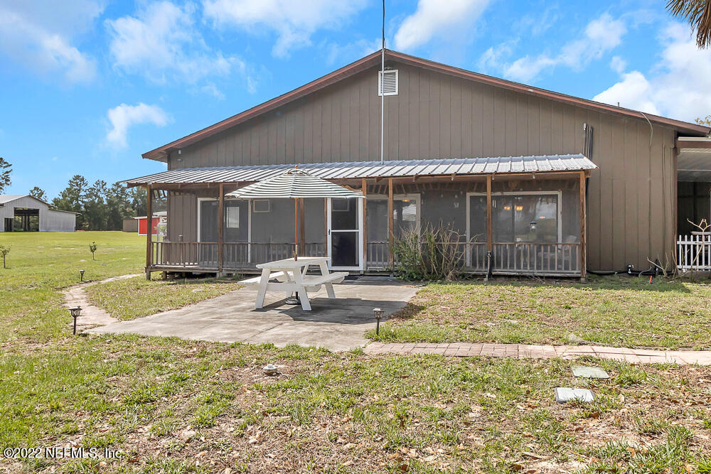 152 Marvin Jones Road Crescent City, FL 32112 - Photo 63 of 83 a backyard of a house with yard and outdoor seating