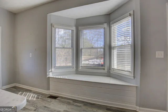 a view of wooden floor and windows in a room