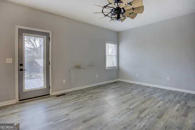 a view of an empty room with a window
