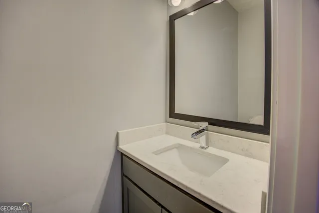 a bathroom with a sink and a mirror