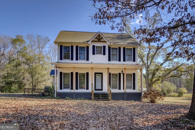 front view of a house with a tree