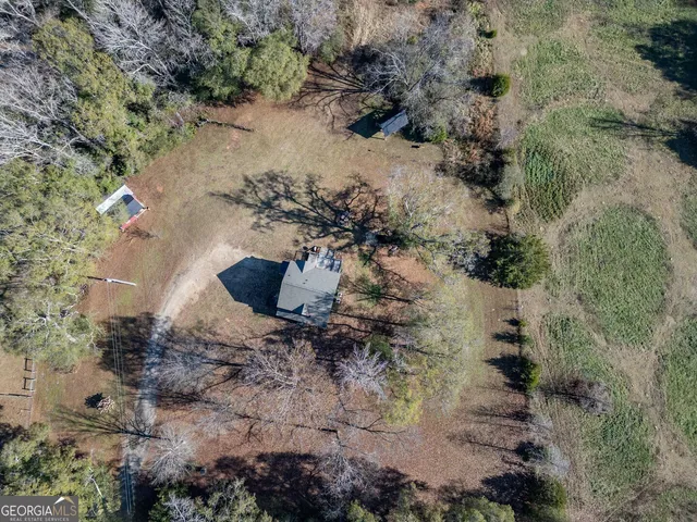 an aerial view of a house with a yard