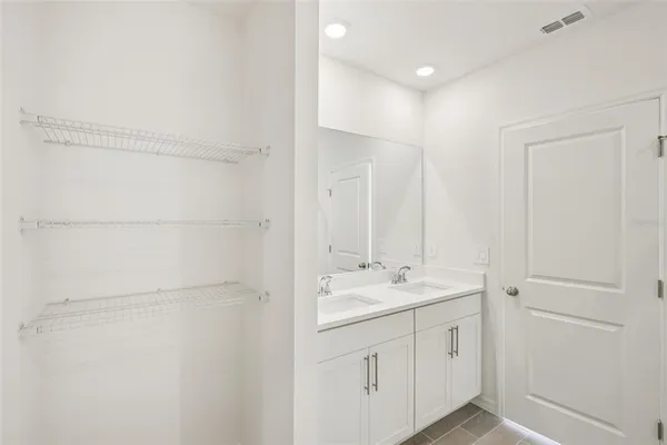 a bathroom with a double vanity sink and a mirror