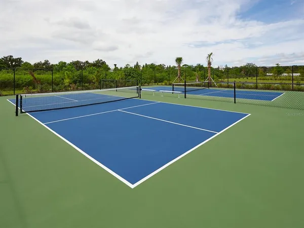 a view of an outdoor space and tennis court