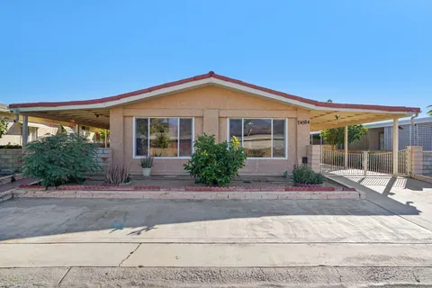 a front view of a house with porch and glass windows