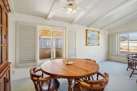 a dining room with furniture and window