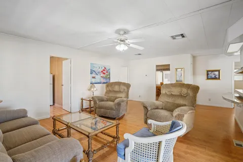 a living room with furniture a rug and a chandelier