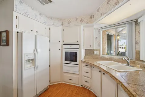 a spacious bathroom with a granite countertop sink mirror and