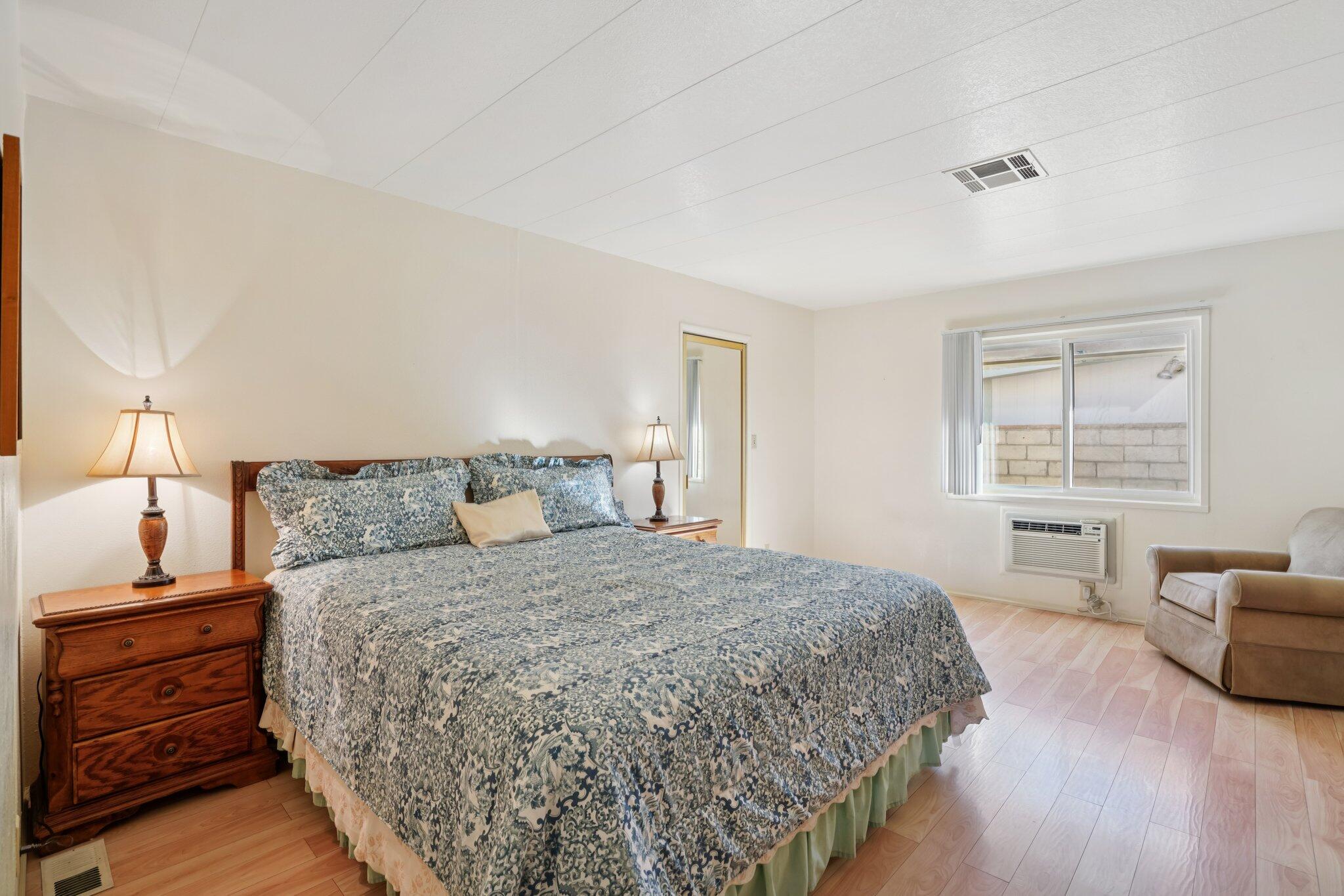 74584 Nevada Circle East Palm Desert, CA 92260 - Photo 20 of 46 a bedroom with a bed and wooden floor