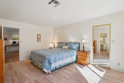 a bedroom with a bed and a mirror