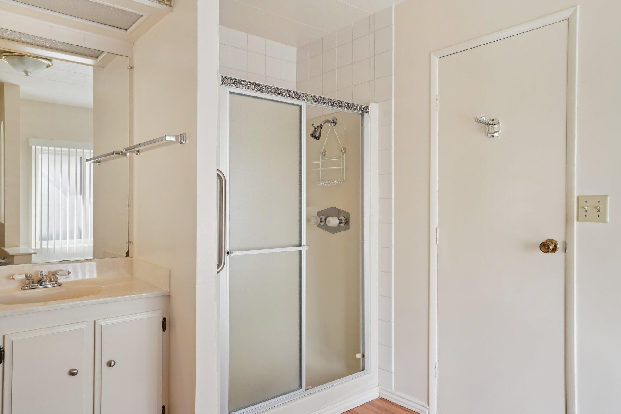 74584 Nevada Circle East Palm Desert, CA 92260 - Photo 26 of 46 a bathroom with a shower sink and mirror