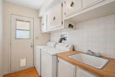 a utility room with sink dryer and washer