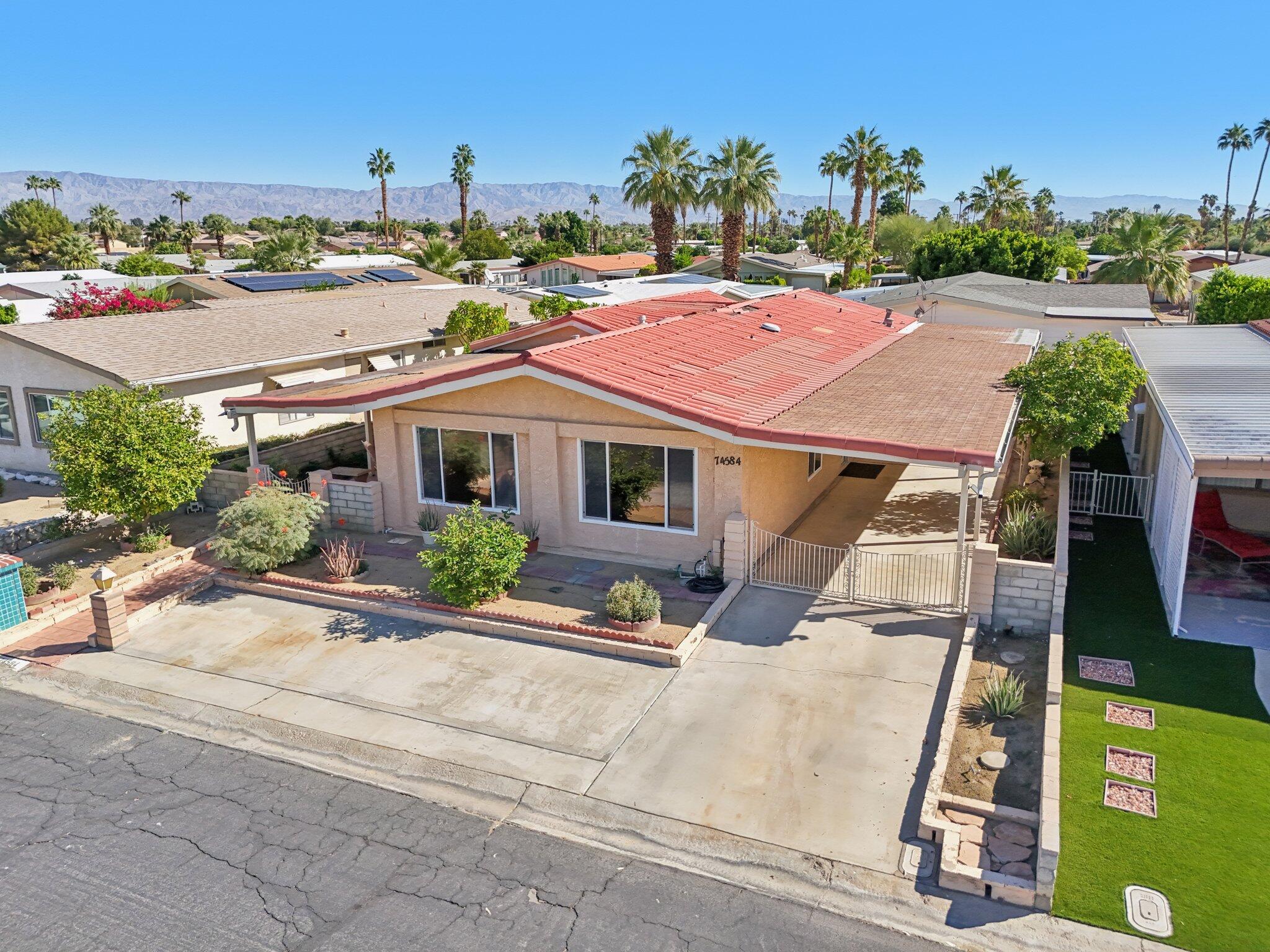 74584 Nevada Circle East Palm Desert, CA 92260 - Photo 38 of 46 a front view of a house with a yard