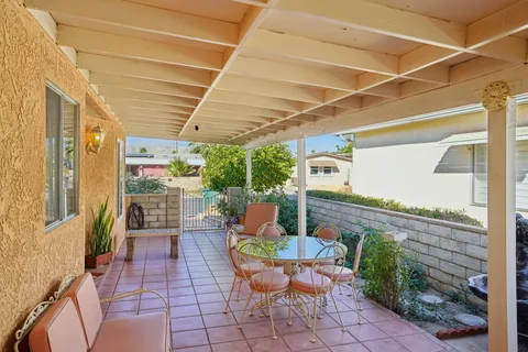 a view of a patio with table and chairs potted plants with wooden floor