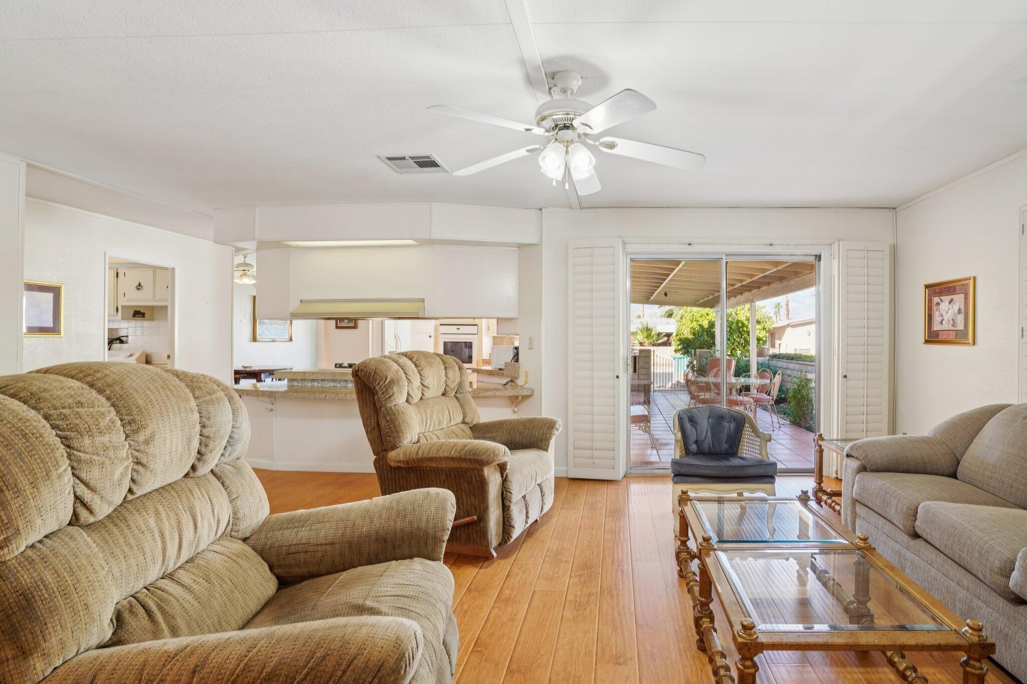 74584 Nevada Circle East Palm Desert, CA 92260 - Photo 8 of 46 a living room with furniture and a large window