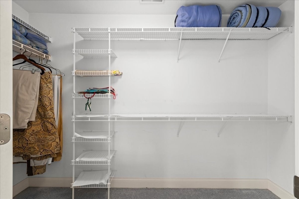 7 Primmett Lane, Unit 7 Worcester, MA 01609 - Photo 23 of 38 a view of walk in closet with clothes and shoes