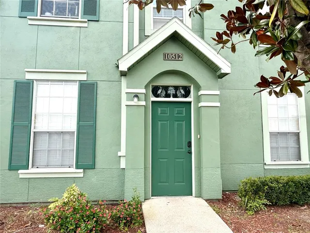 a view of a brick house with a small yard