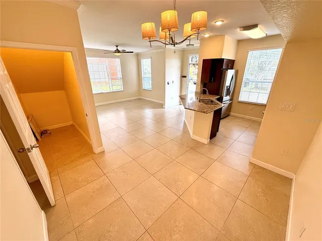 a kitchen with granite countertop wooden cabinets and stainless steel appliances