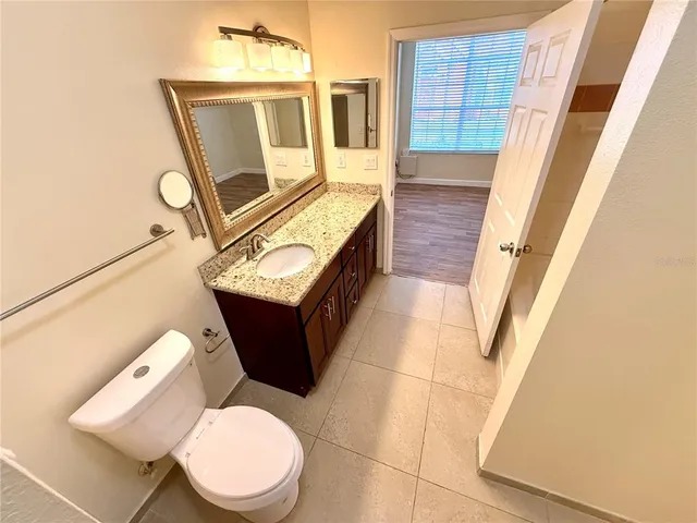 a white toilet sitting next to a bathroom sink