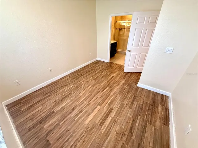 a view of walk in closet with rug and wooden floor