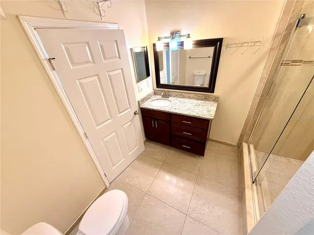 a bathroom with a shower and a sink
