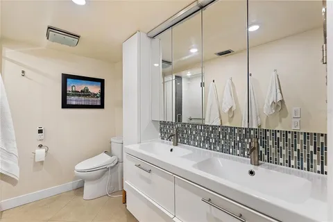 a bathroom with a sink a toilet and a shower
