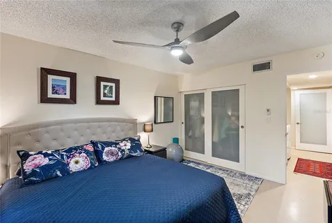 a bedroom with a bed and a chandelier