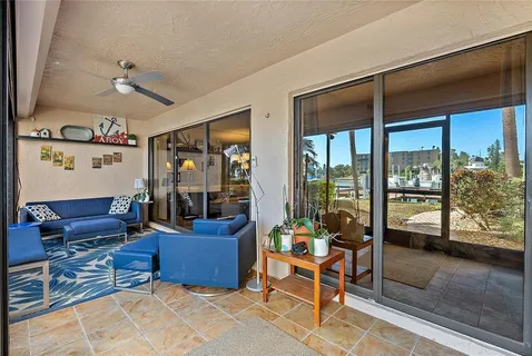 a living room with furniture and a floor to ceiling window