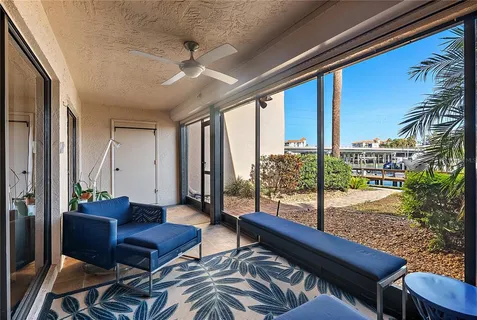 a living room with furniture and a floor to ceiling window