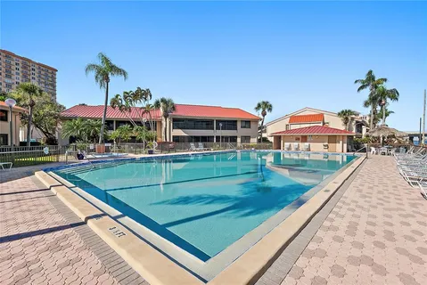 a view of balcony with swimming pool and sitting area