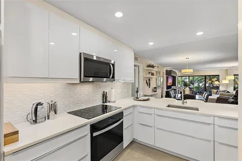 a kitchen with sink stainless steel appliances and cabinets