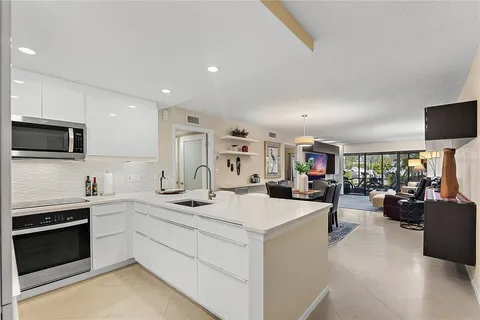 a kitchen with a sink stove and cabinets