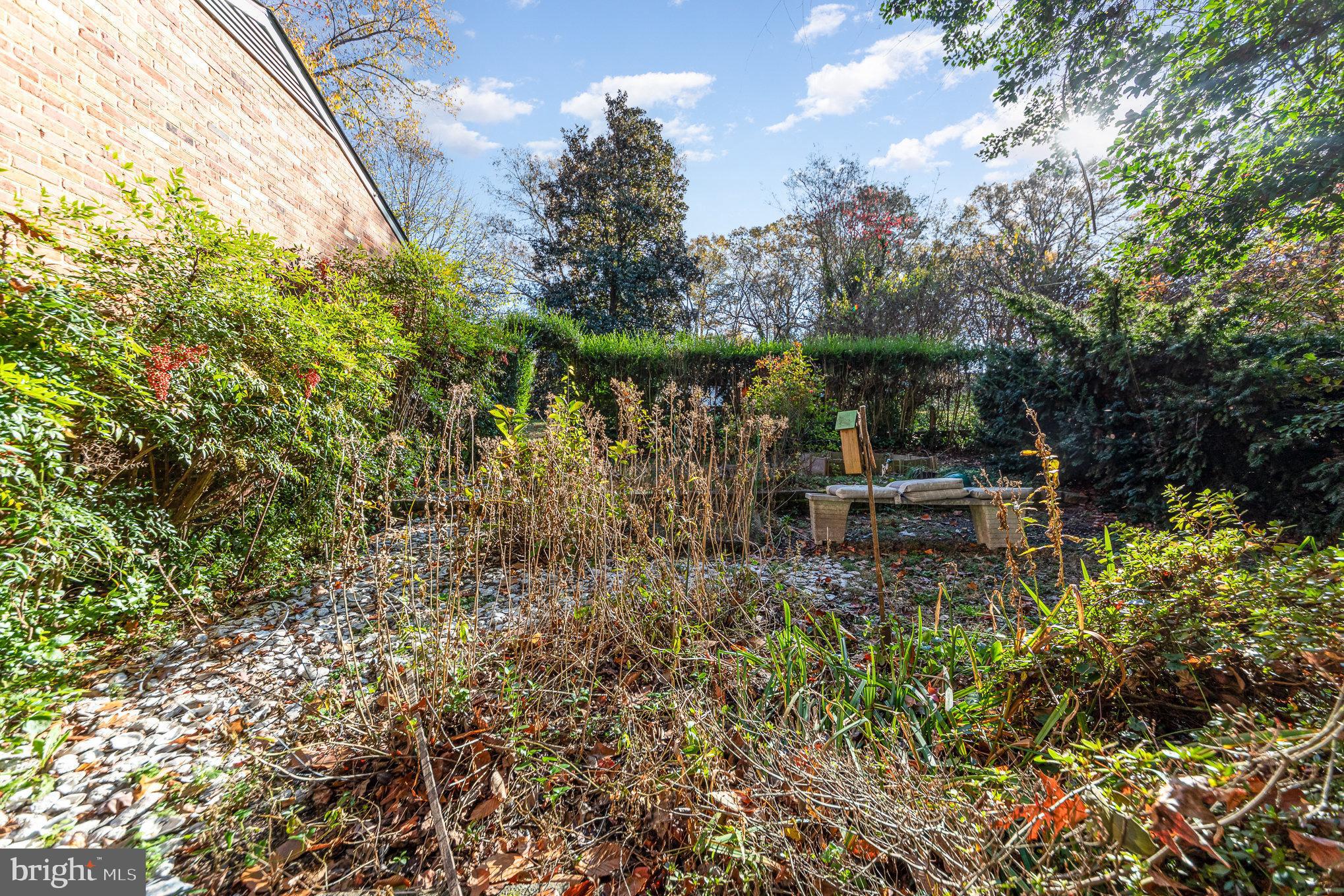 13000 Silver Crest Road Chester, VA 23831 - Photo 28 of 28 a wooden bench sitting in the middle of a garden