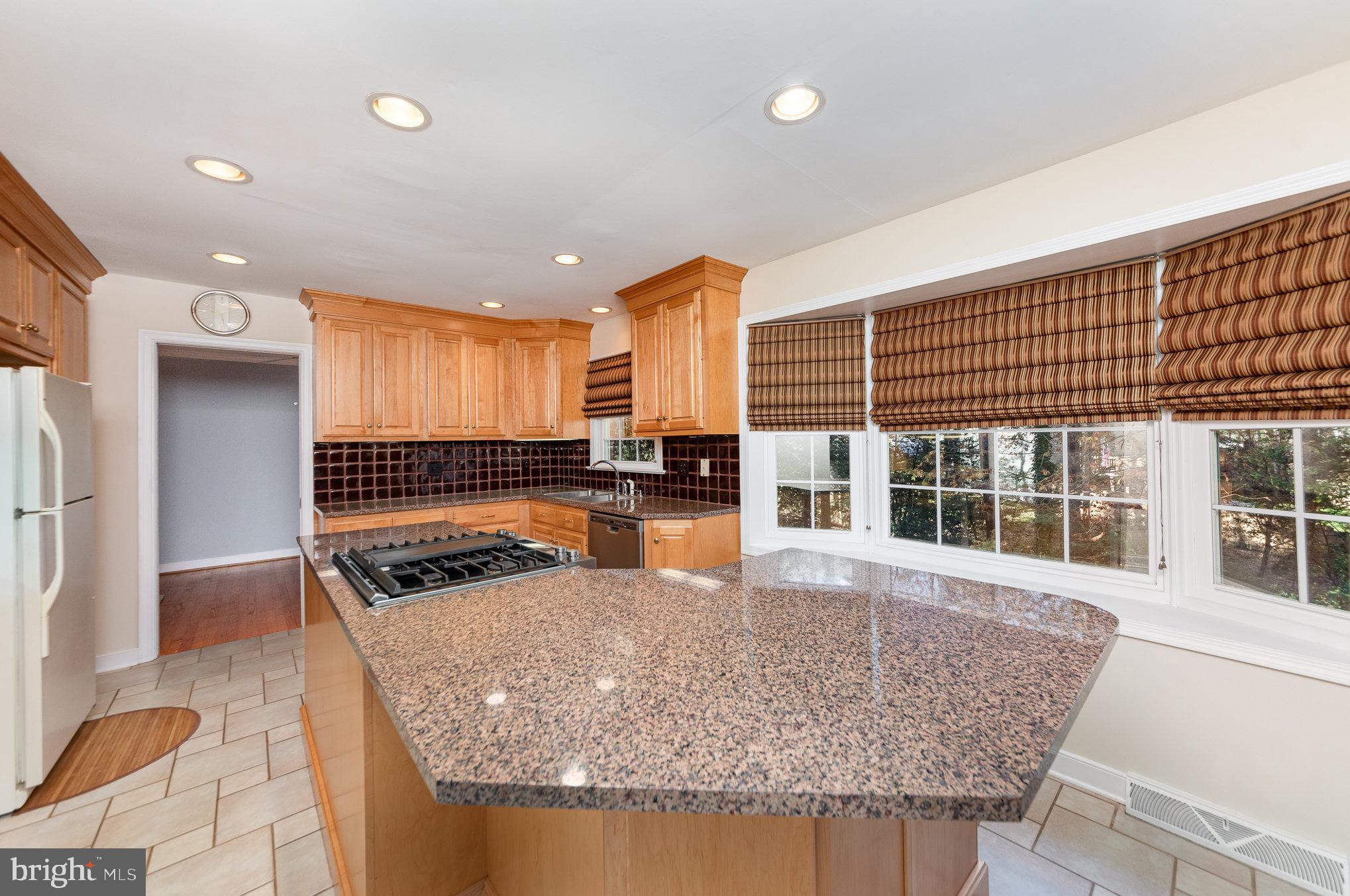 13000 Silver Crest Road Chester, VA 23831 - Photo 7 of 28 a kitchen with stainless steel appliances granite countertop a stove and a sink