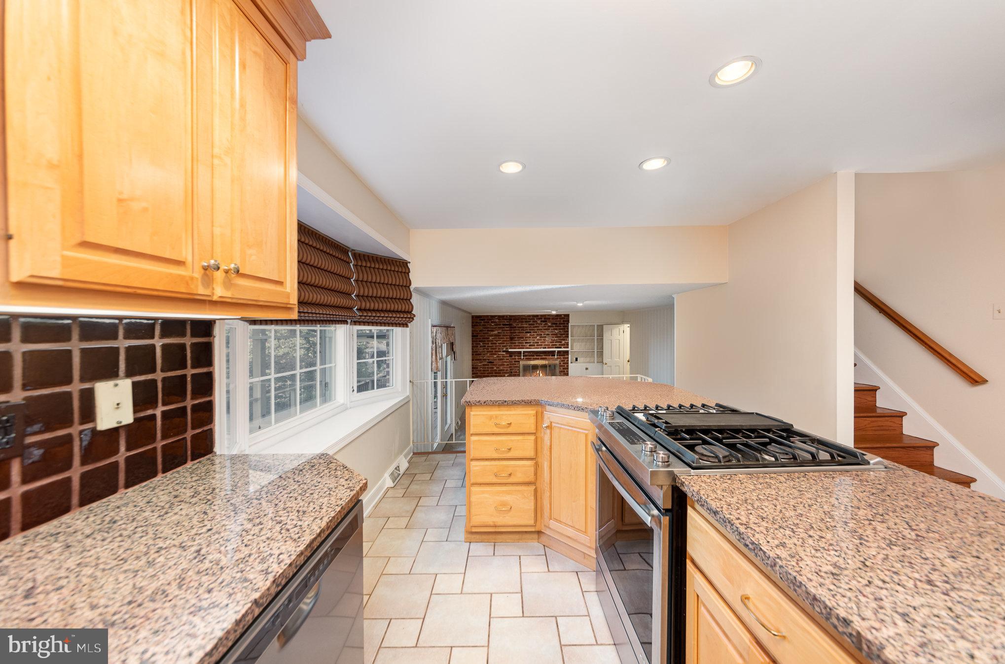 13000 Silver Crest Road Chester, VA 23831 - Photo 8 of 28 a kitchen with stainless steel appliances granite countertop a stove a sink and a microwave