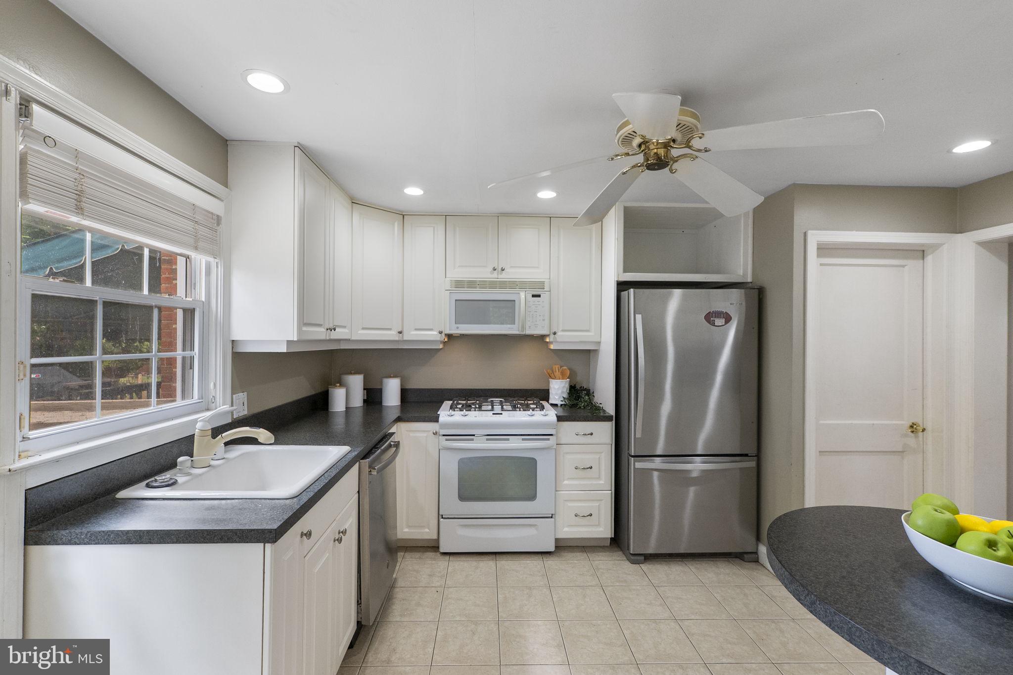 1541 Doxbury Road Baltimore, MD 21286 - Photo 11 of 37 a kitchen with a sink stainless steel appliances and cabinets