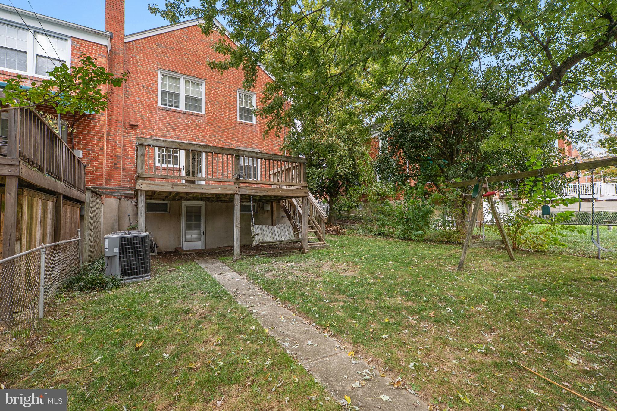 1541 Doxbury Road Baltimore, MD 21286 - Photo 16 of 37 a view of a brick house with a big yard and large trees